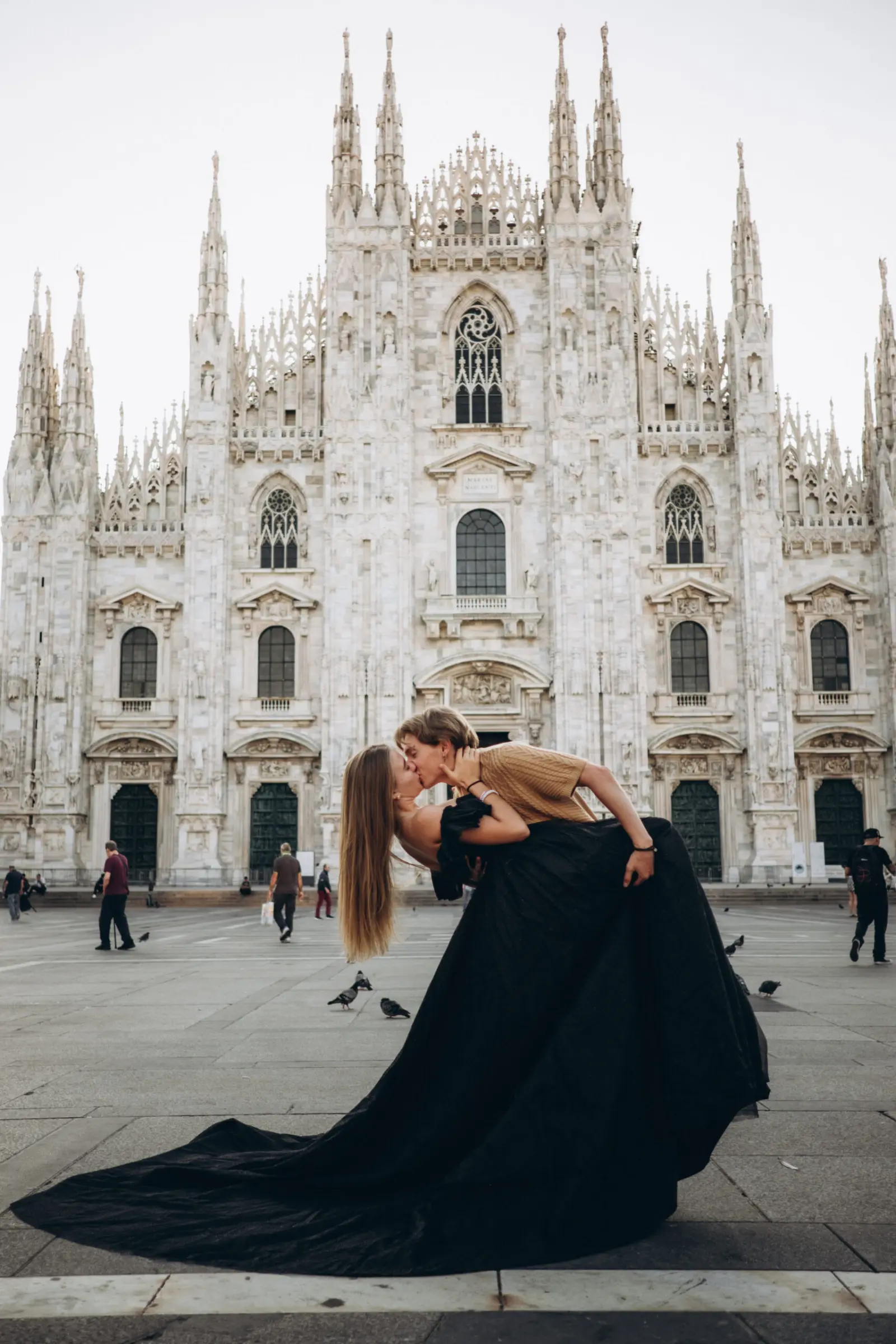 Black gown with a dramatic skirt in front of the Duomo