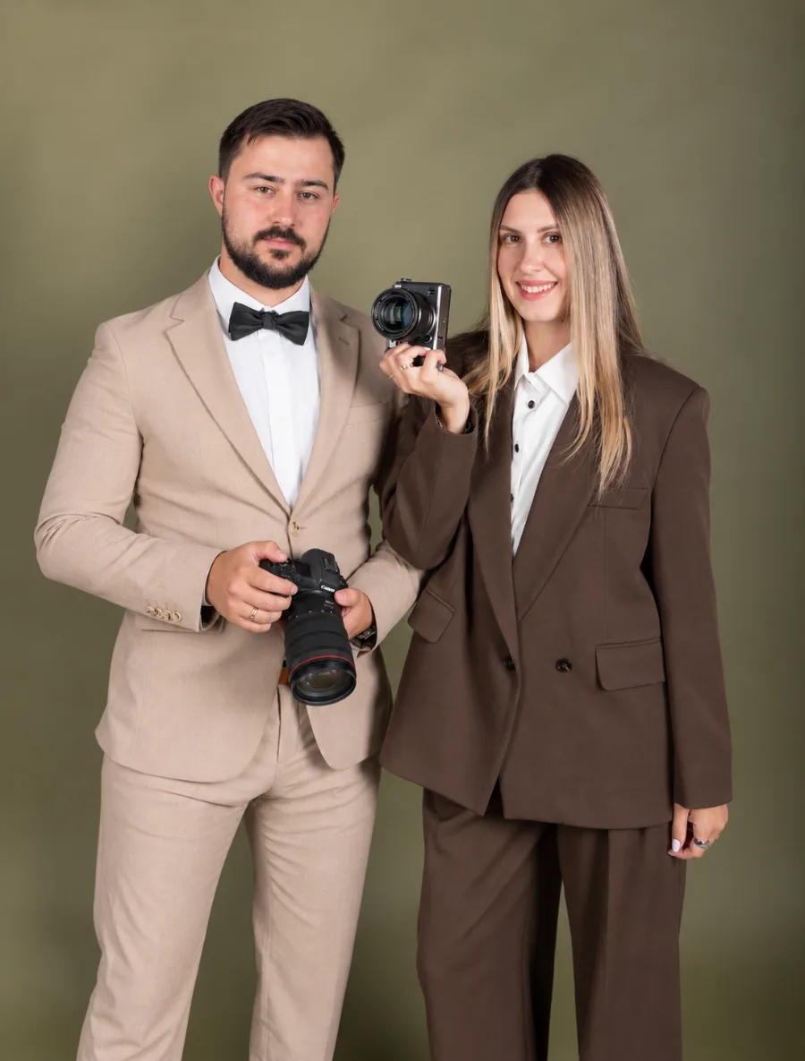 Anatoly and Julia, wedding photographers, holding their cameras