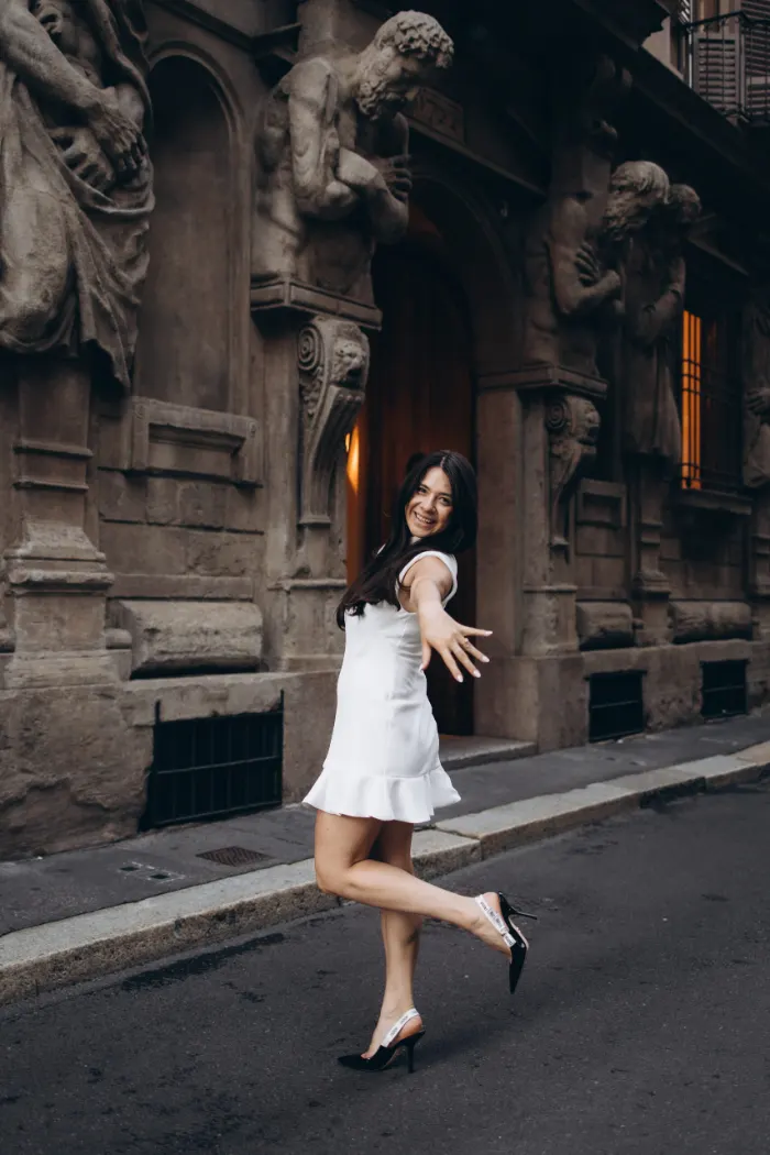 Woman twirling by Casa degli Omenoni, Milan