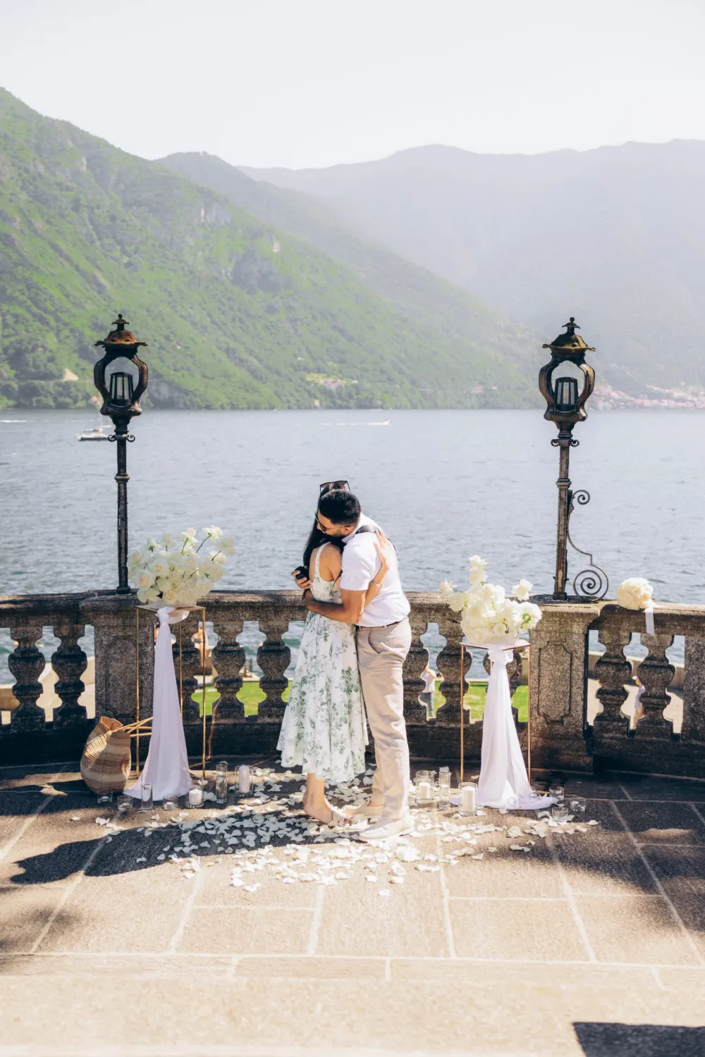 Couple hugging right after a surprise proposal on Lake Como
