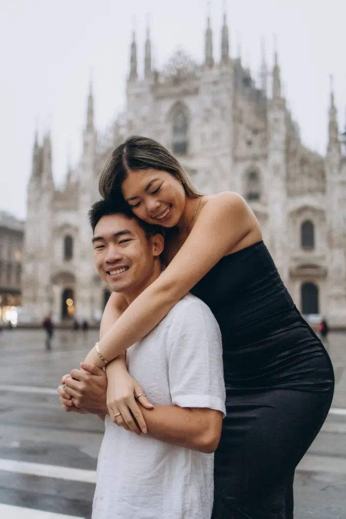 Lovely couples hugs in front of Duomo in Milan