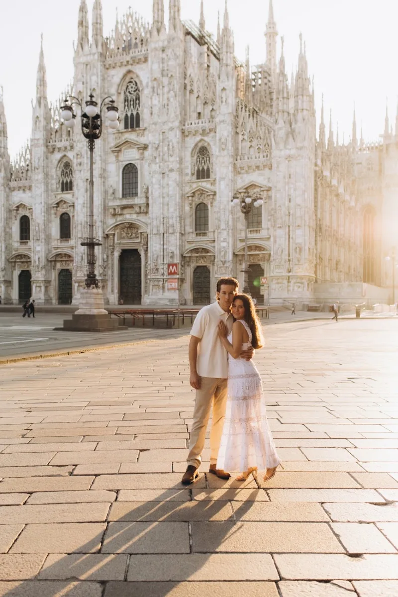 Couple standing in the empty Piazza del Duomo early in the morning, Milan