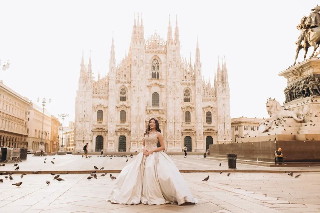 Woman in a ball gown in the empty Piazza del Duomo early in the morning, Milan