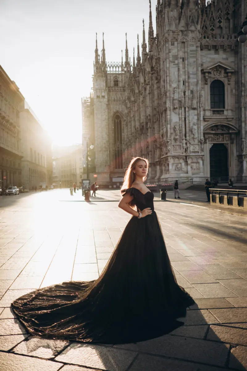 Woman in a black gown with a full skirt on a Milan street