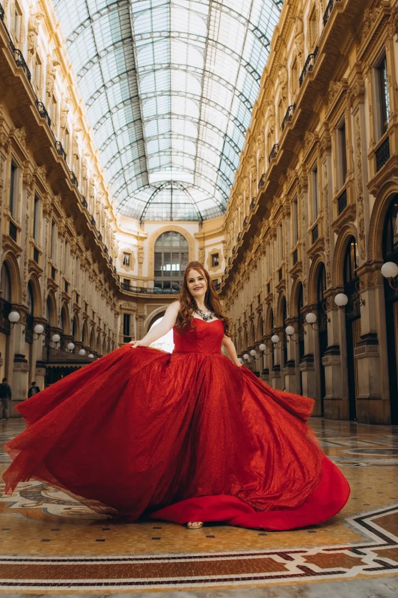 Woman twirling a red gown under the glass dome of the Galleria Vittorio Emanuele II