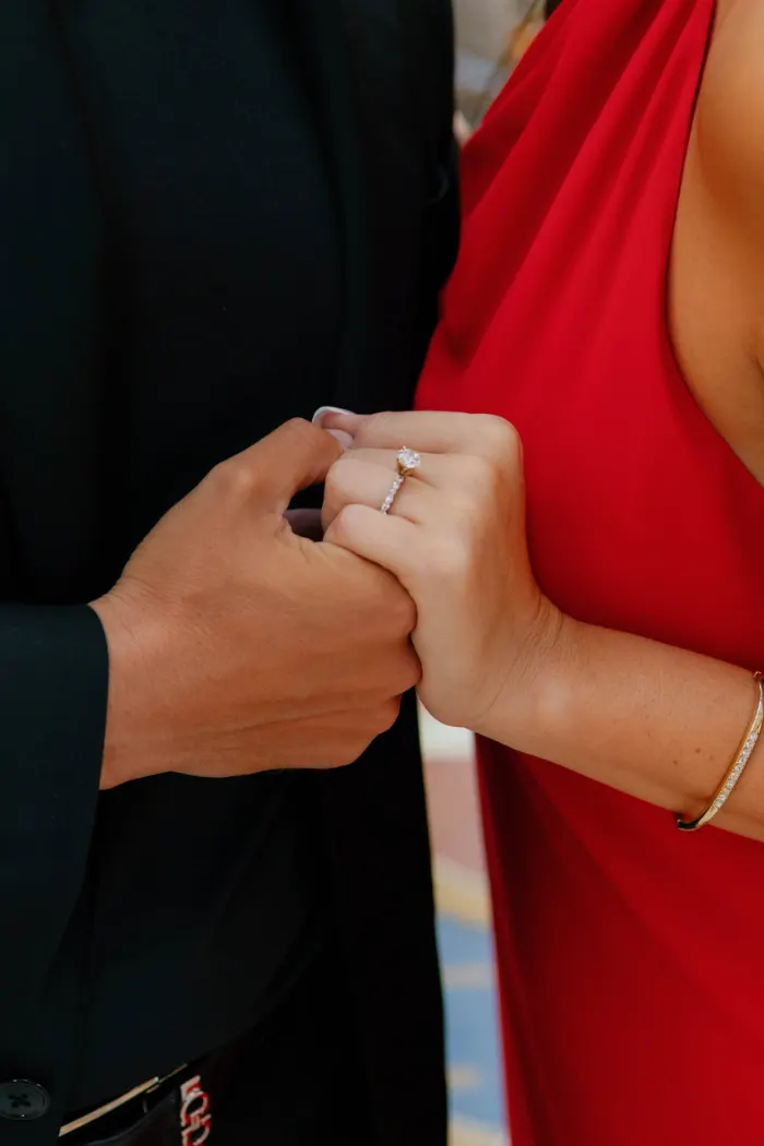 Close-up of an engaged couple's hands showing the ring in the Galleria