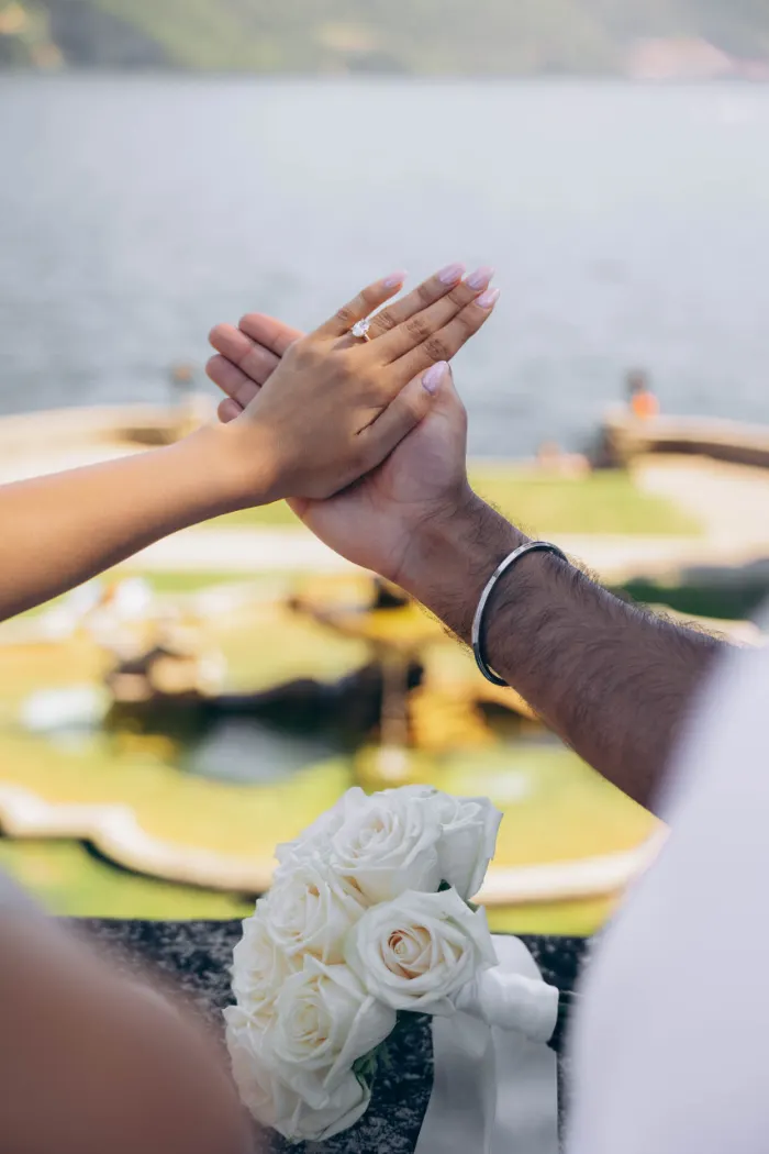 Engagement ring and white roses after a proposal on Lake Como