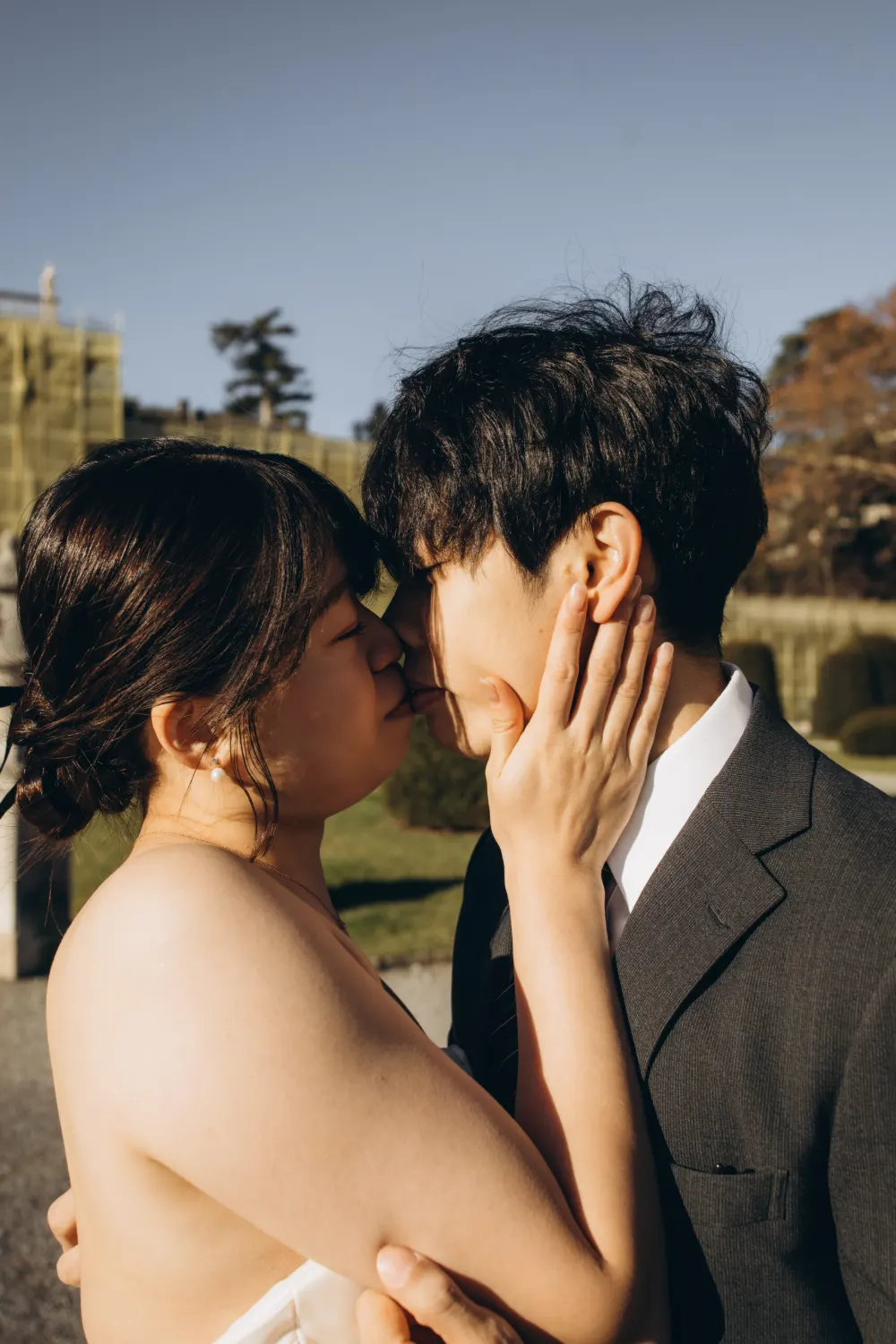 Couple about to kiss in golden light on Lake Como