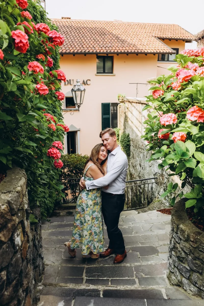 Couple embracing by pink hydrangeas in Varenna, Lake Como