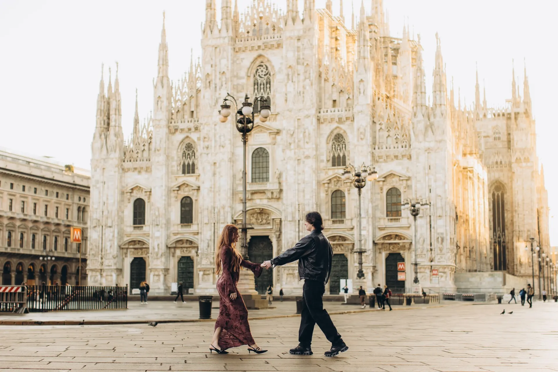 Couple dancing in front of the Duomo at sunrise, Milan