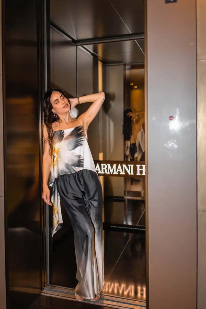 Woman with eyes closed in a mirrored hotel alcove in Milan