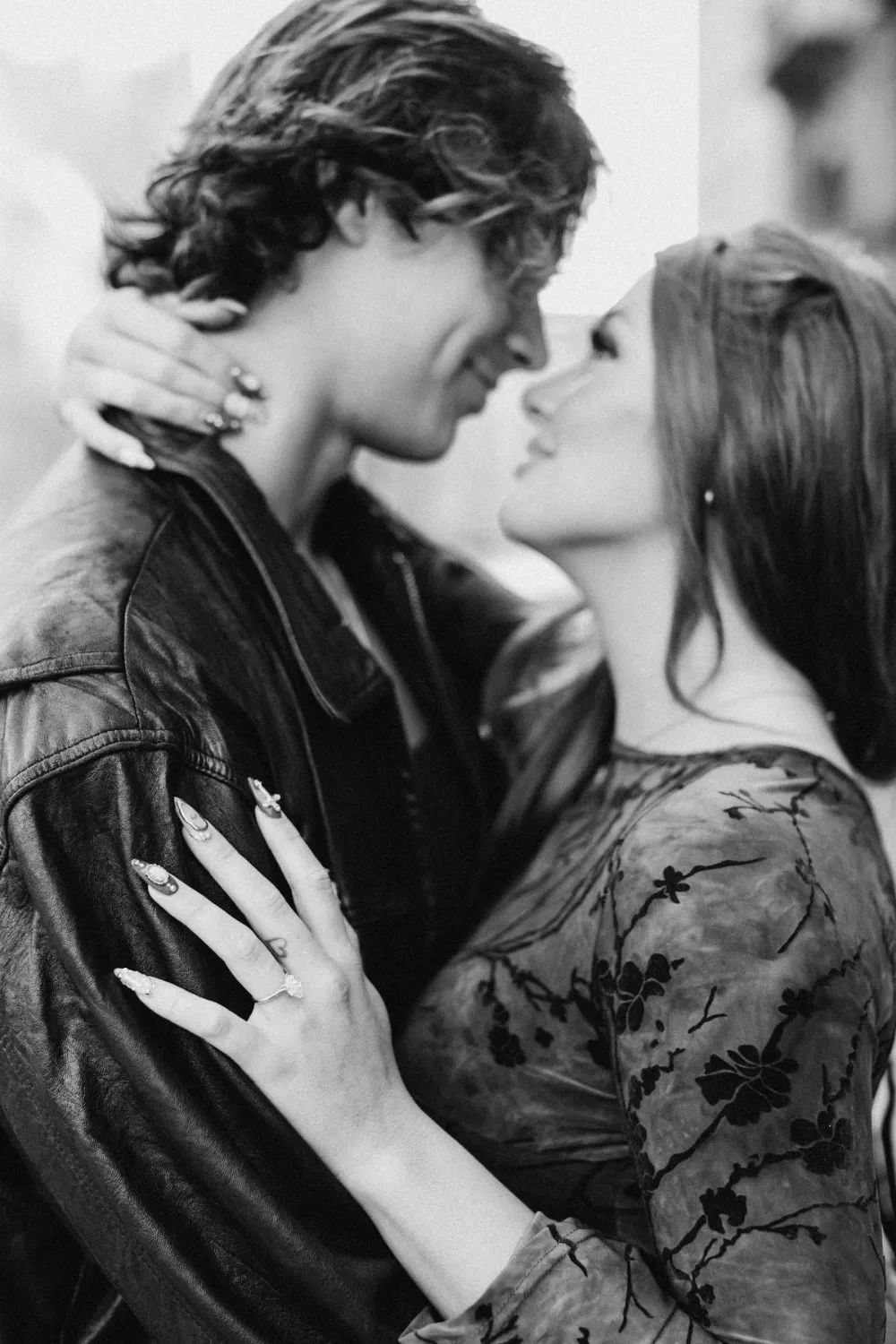 Black and white photo of the couple about to kiss after the proposal in Milan
