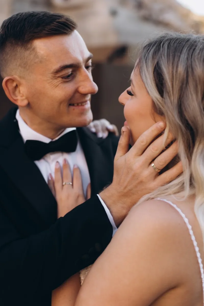 Bride touching the groom’s cheek as they smile, Milan