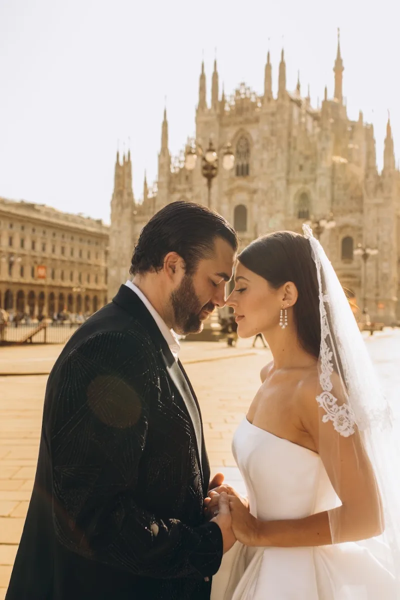 Bride and groom nose to nose under her veil in the morning sun, Duomo di Milano