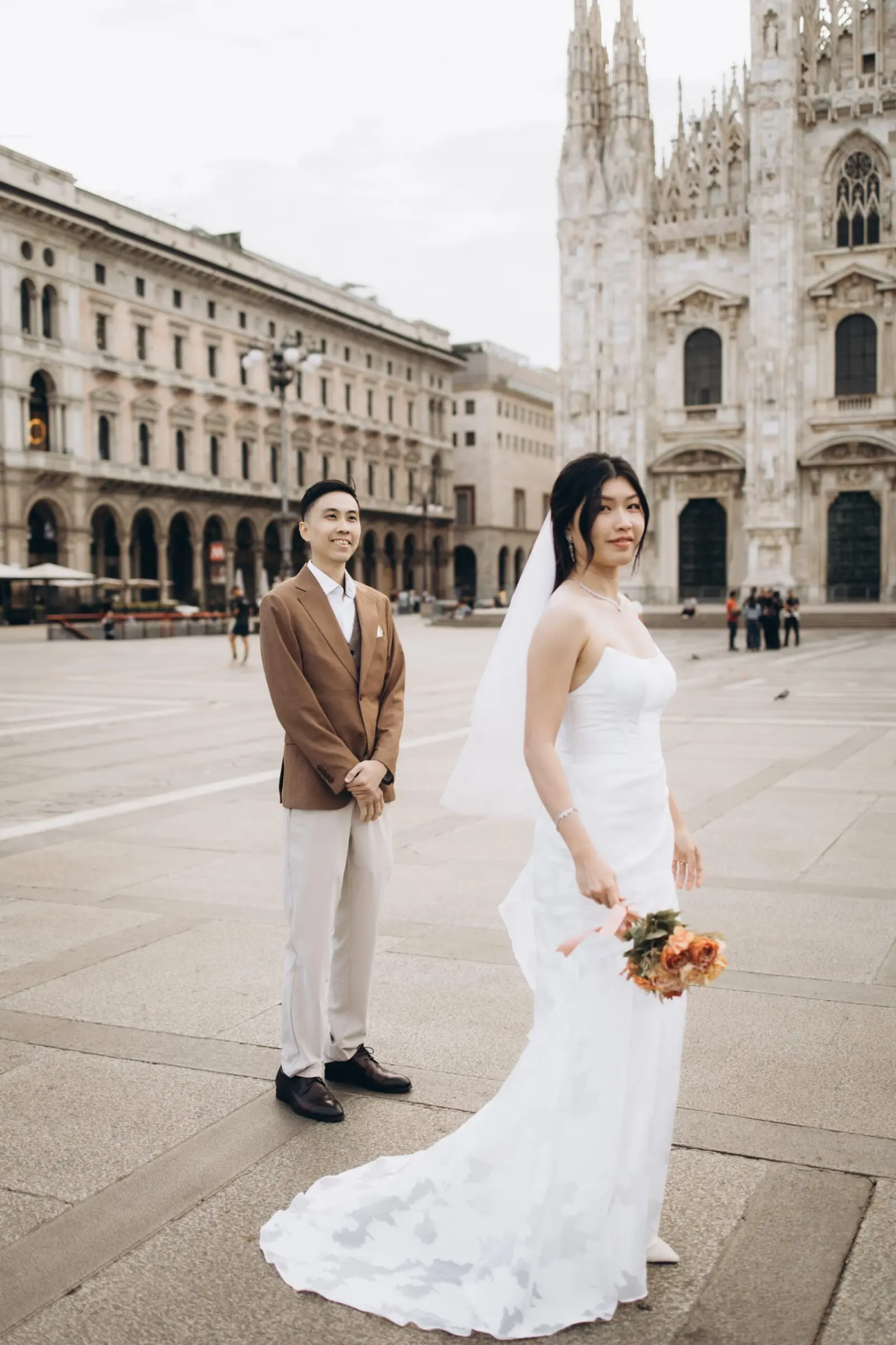 Bride and groom near the Duomo in Milan on their wedding day