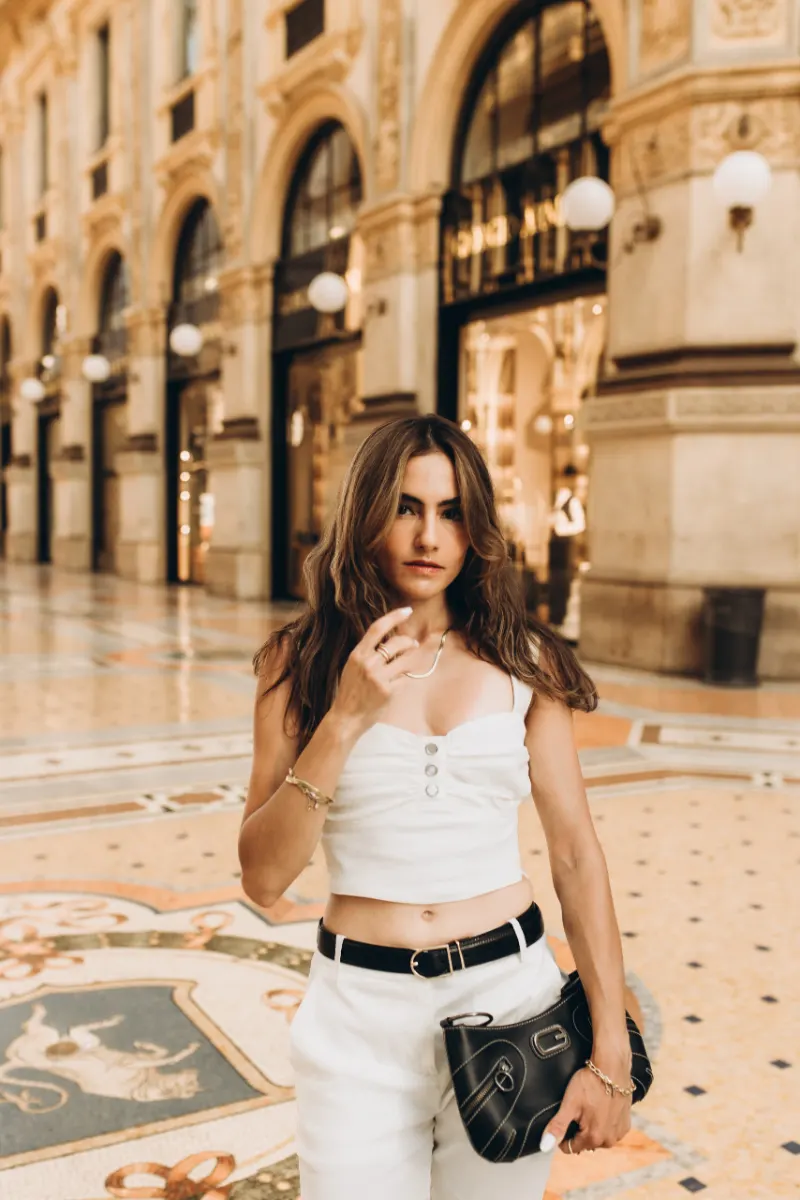 Woman in white on the mosaic floor of Galleria Vittorio Emanuele II during a personal photoshoot in Milan