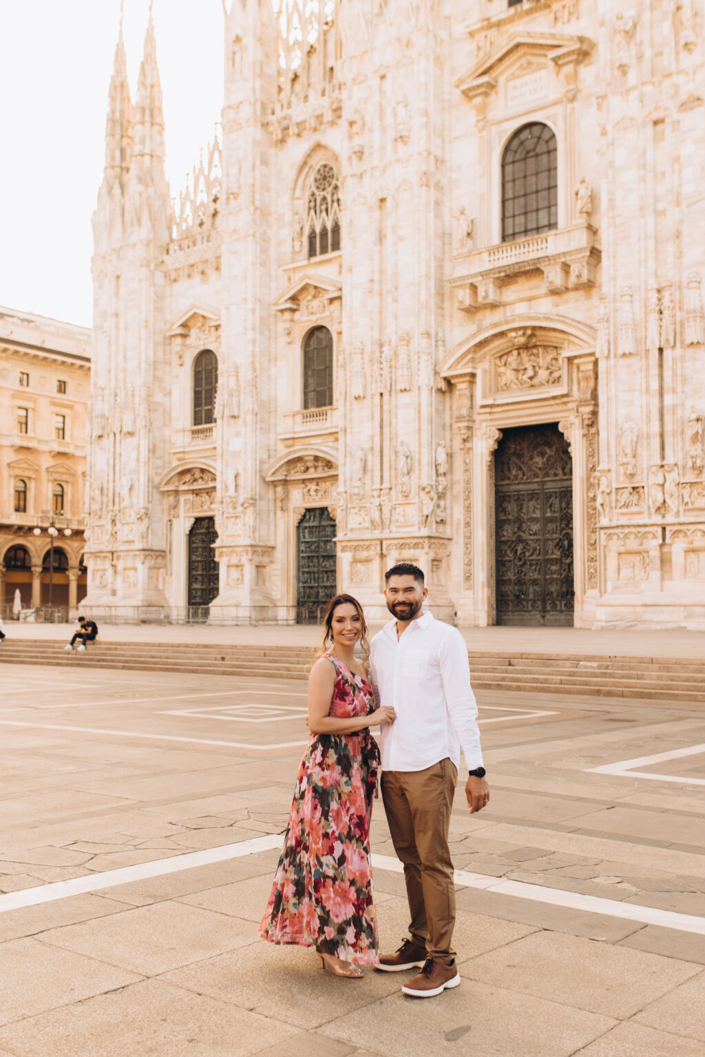 The quinceañera's parents stand together before the Duomo di Milano in Piazza del Duomo.