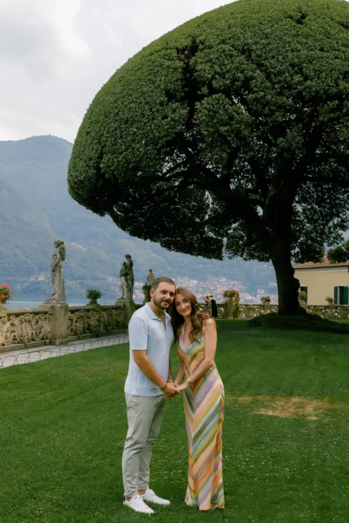 A couple on the lawn of Villa del Balbianello above Lake Como